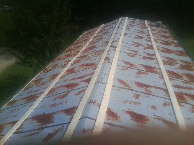Rusted metal roof panels with new wood purlins before replacement — Storm Damage Roof Repair in Soda Springs by Roofing Brothers